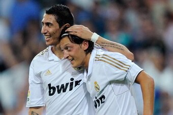 MADRID, SPAIN - AUGUST 14: Mesut Oezil (R) of Real Madrid celebrates with Angel Di Maria after scoring Real's opening goal during the Super Cup first leg match between Real Madrid and Barcelona at Estadio Santiago Bernabeu on August 14, 2011 in Madrid, Sp