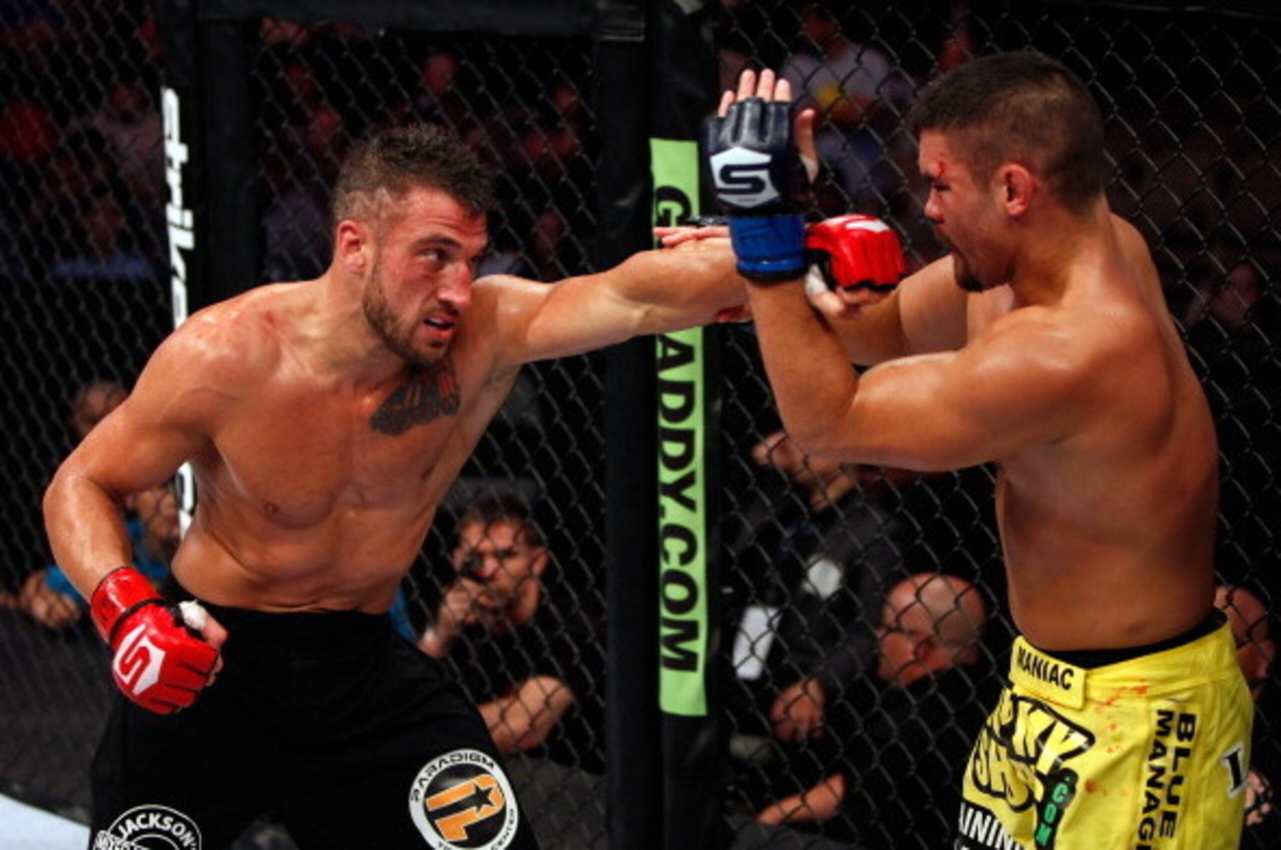 DALLAS, TX - JUNE 18:  Mike Bronzoulis (black shorts) punches Todd Moore (yellow shorts) during a Welterweight bout at the Strikeforce event at American Airlines Center on June 18, 2011 in Dallas, Texas.  (Photo by Esther Lin/Zuffa LLC/Forza LLC via Getty