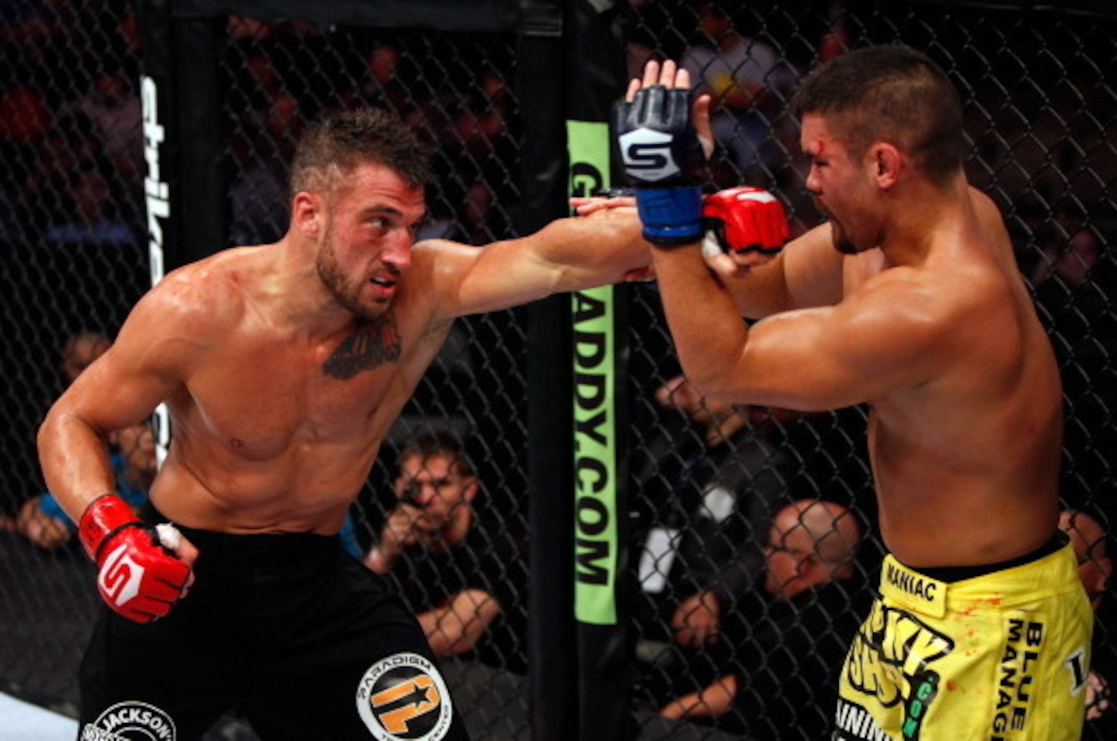 DALLAS, TX - JUNE 18:  Mike Bronzoulis (black shorts) punches Todd Moore (yellow shorts) during a Welterweight bout at the Strikeforce event at American Airlines Center on June 18, 2011 in Dallas, Texas.  (Photo by Esther Lin/Zuffa LLC/Forza LLC via Getty