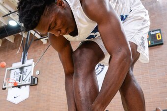 Detroit Pistons rookie Stanley Johnson ties his shoes at the Drew League.