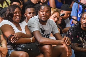 Kevin Durant watches the 2015 Drew League championship game from his courtside seat.