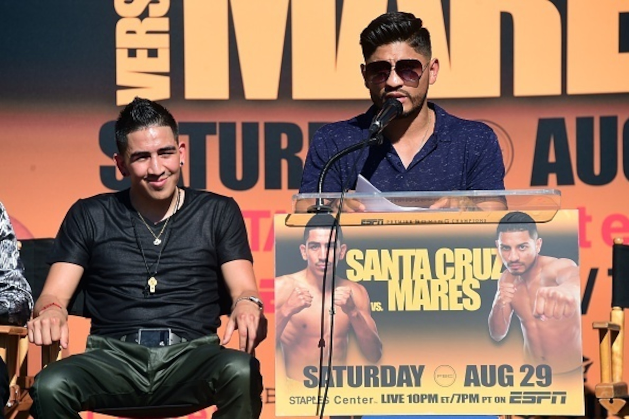 Undefeated two-Division World Champion Leo 'El Terremoto' Santa Cruz (L) looks on as former three-division world champion Abner Mares (R)  speaks at a press conference in Los Angeles on July 14, 2015, to announce their 12-round featherweight fight taking 