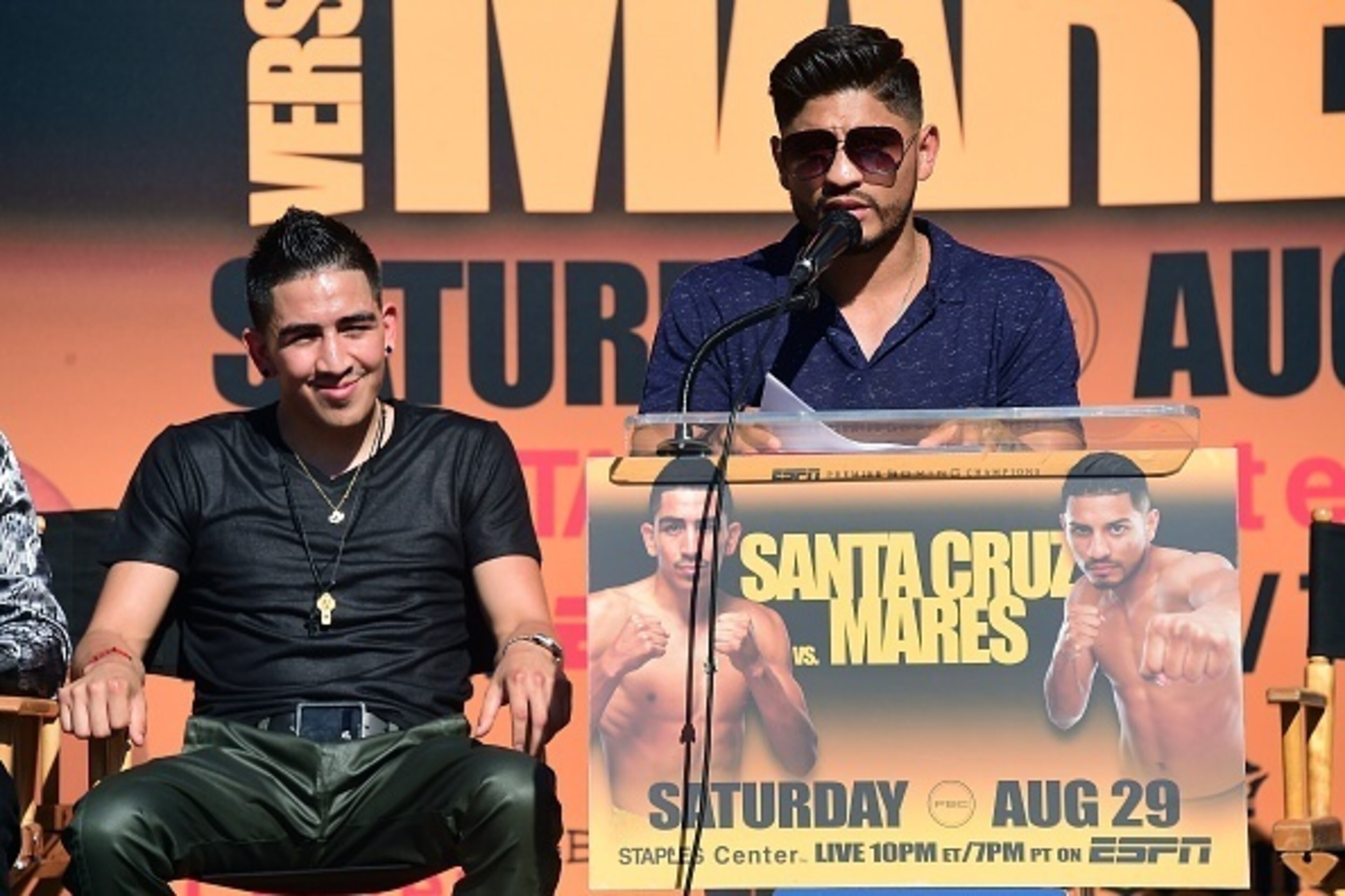 Undefeated two-Division World Champion Leo 'El Terremoto' Santa Cruz (L) looks on as former three-division world champion Abner Mares (R)  speaks at a press conference in Los Angeles on July 14, 2015, to announce their 12-round featherweight fight taking 