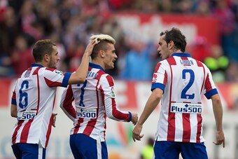 MADRID, SPAIN - APRIL 25: Antoine Griezmann (C) of Atletico de Madrid celebrates scoring their second goal with team mate Koke (L) and Diego Godin (R) during the La Liga match between Club Atletico de Madrid and Elche FC at Vicente Calderon Stadium on Apr