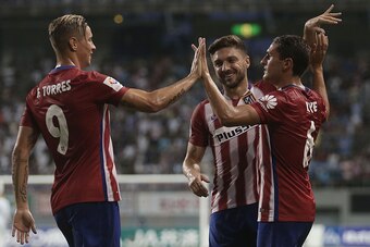 TOSU, JAPAN - AUGUST 01: Koke #6 of Atletico Madrid is congratulated by team mates Fernando Torres #9 and Guilherme Siqueira #3 after scoring a goal from a corner kick against Sagan Tosu F.C. during the friendly match between Atletico Madrid and Sagan Tos