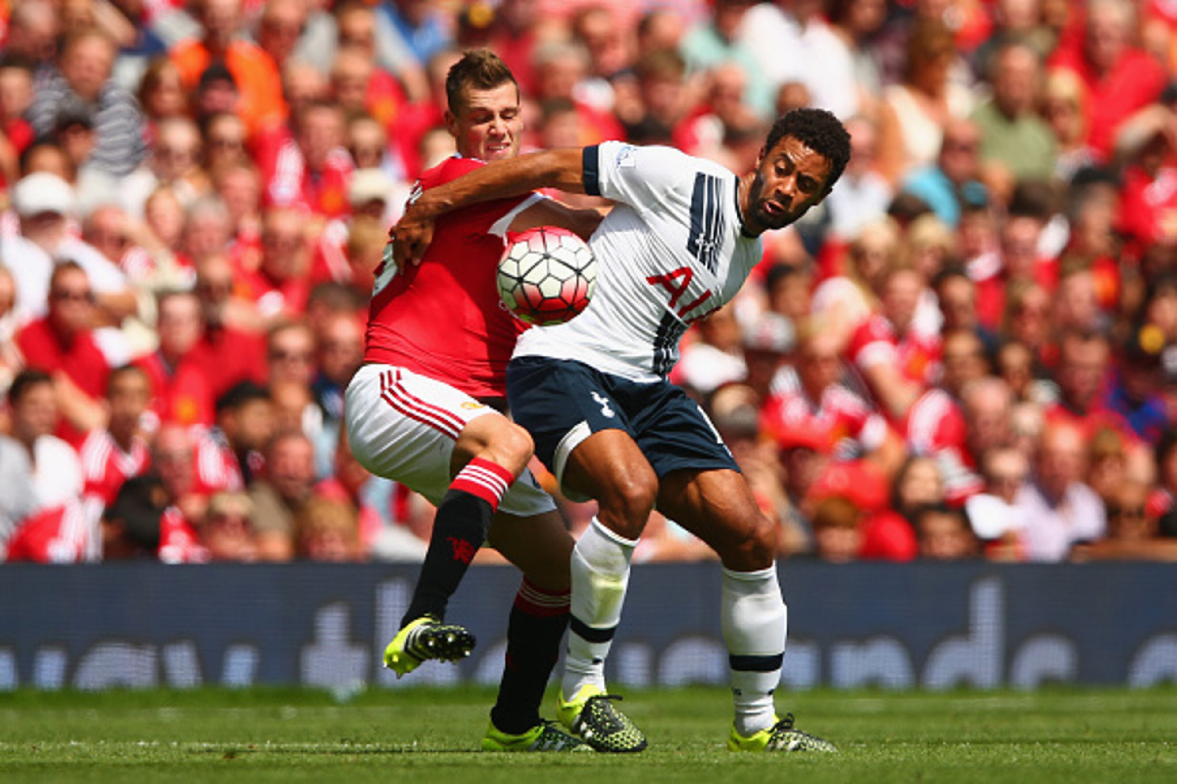 MANCHESTER, ENGLAND - AUGUST 08:  Morgan Schneiderlin of Manchester United and Mousa Dembele of Tottenham Hotspur compete for the ball during the Barclays Premier League match between Manchester United and Tottenham Hotspur at Old Trafford on August 8, 20