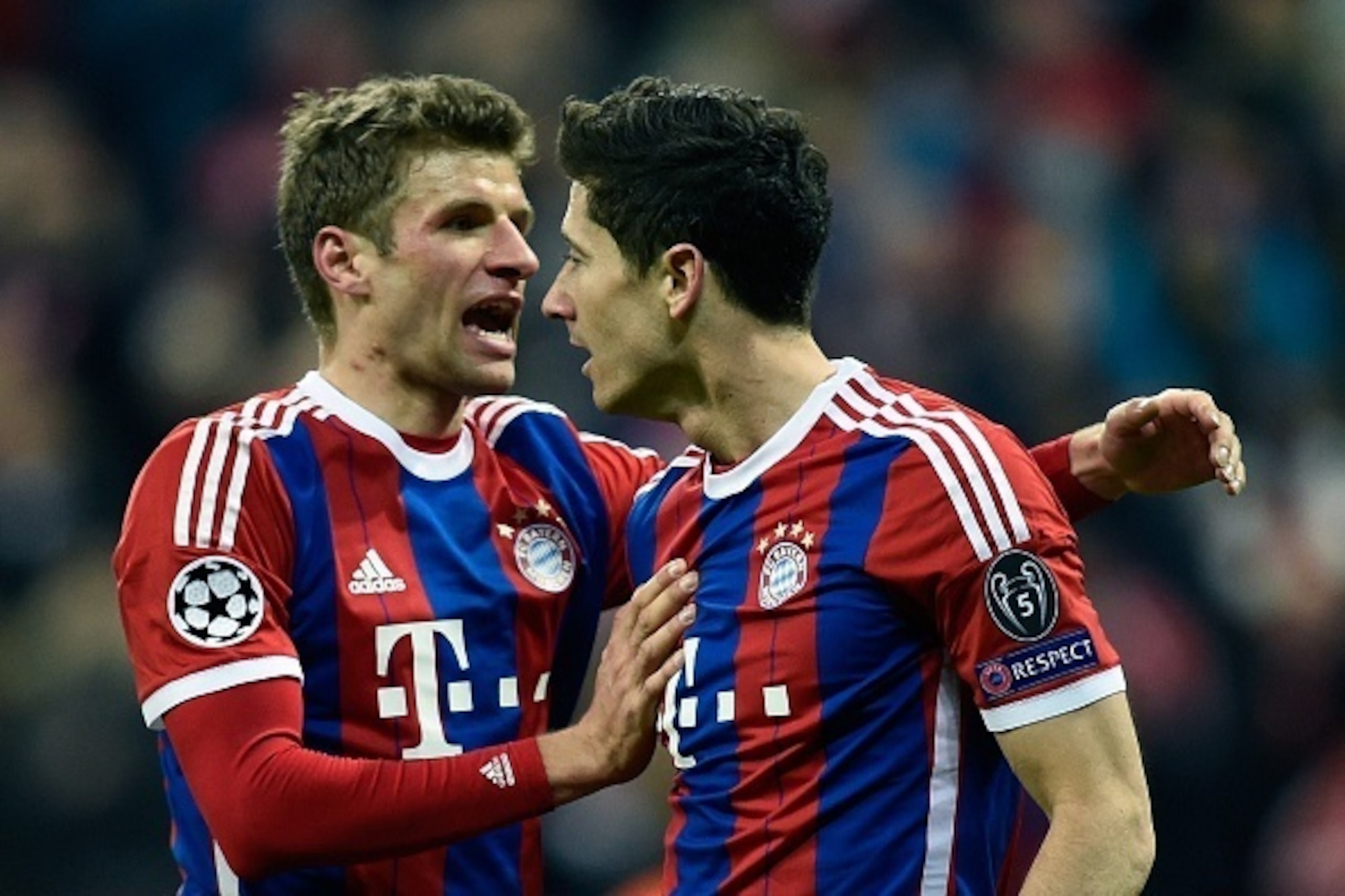 Bayern Munich's Polish striker Robert Lewandowski celebrates scoring the 6-0 goal with midfielder Thomas Mueller (L) during the UEFA Champions League second-leg, Round of 16 football match FC Bayern Munich vs Shakhtar Donetsk in Munich, southern Germany, 