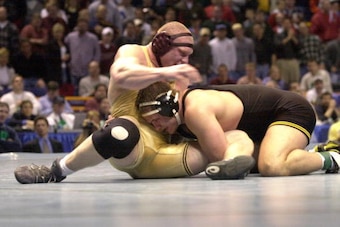 N366242 04: Brock Lesnar of Minnesota, left, fends off Wes Hand of Iowa in their heavyweight championship wrestling match at the 2000 NCAA Wrestling Championships at the Kiel Center, in St. Louis, Mo., March 18, 2000. Lesnar beat Hand 3-2. (Photo by Bill 