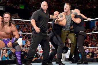 Security holds back Stephen Amell on Raw.