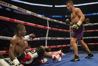 French-Cameroonian boxer Hassan N'Dam goes down for the 2nd time in the 4th round against Canadian David Lemieux as they battle for the IBF world middleweight championship in Montreal, Canada, on June 20, 2015. AFP PHOTO/PETER MCABE        (Photo credit s