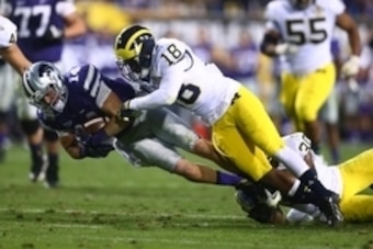 Dec 28, 2013; Tempe, AZ, USA; Michigan Wolverines defensive back Blake Countess (18) tackles Kansas State Wildcats wide receiver Curry Sexton (14) during the Buffalo Wild Wings Bowl at Sun Devil Stadium. Mandatory Credit: Mark J. Rebilas-USA TODAY Sports