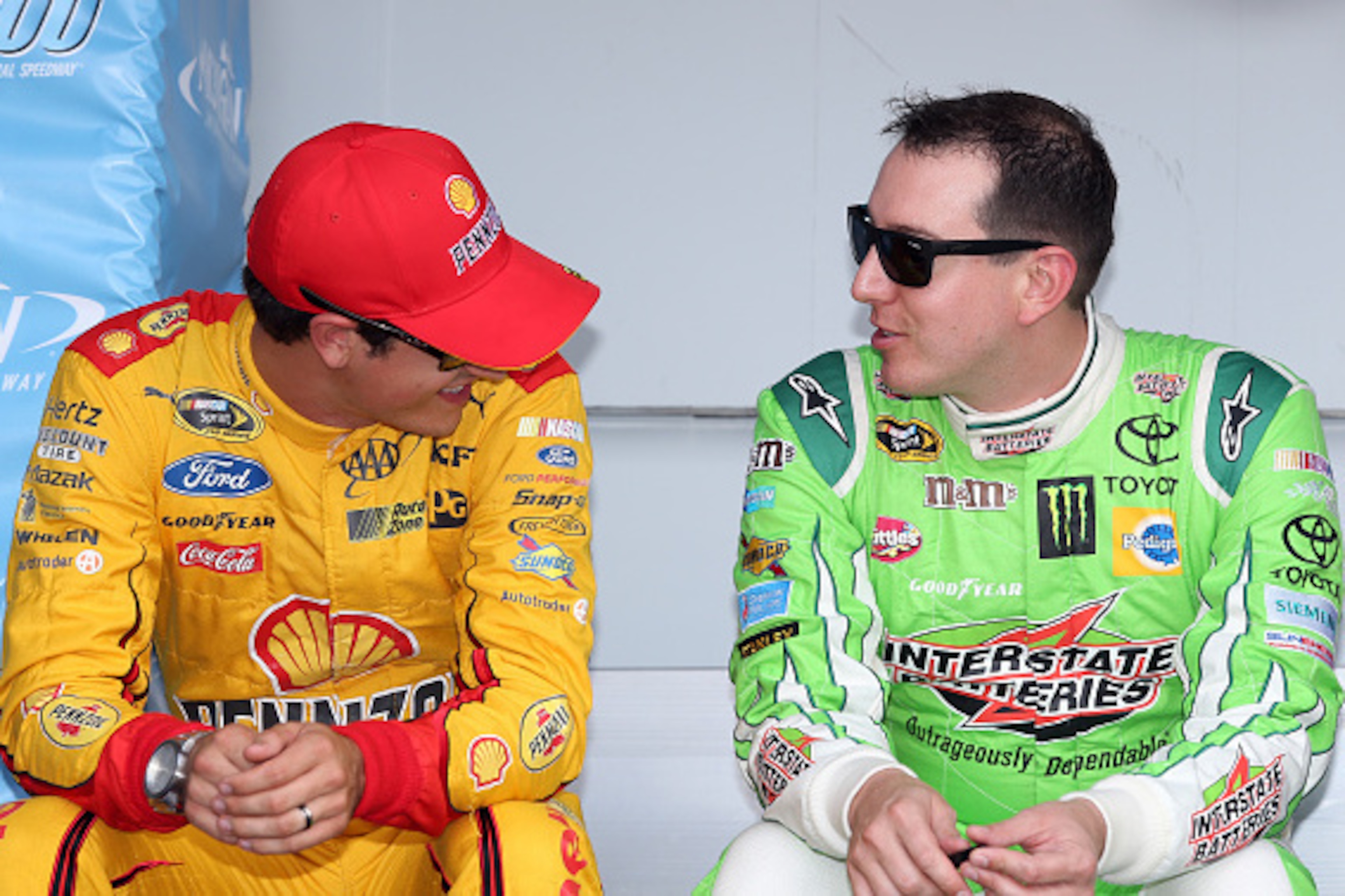 BROOKLYN, MI - AUGUST 16: (L-R) Joey Logano, driver of the #22 Shell Pennzoil Ford, talks to Kyle Busch, driver of the #18 Interstate Batteries Toyota, before the NASCAR Sprint Cup Series Pure Michigan 400 at Michigan International Speedway on August 16, BROOKLYN, MI - AUGUST 16: (L-R) Joey Logano, driver of the #22 Shell Pennzoil Ford, talks to Kyle Busch, driver of the #18 Interstate Batteries Toyota, before the NASCAR Sprint Cup Series Pure Michigan 400 at Michigan International Speedway on August 16,