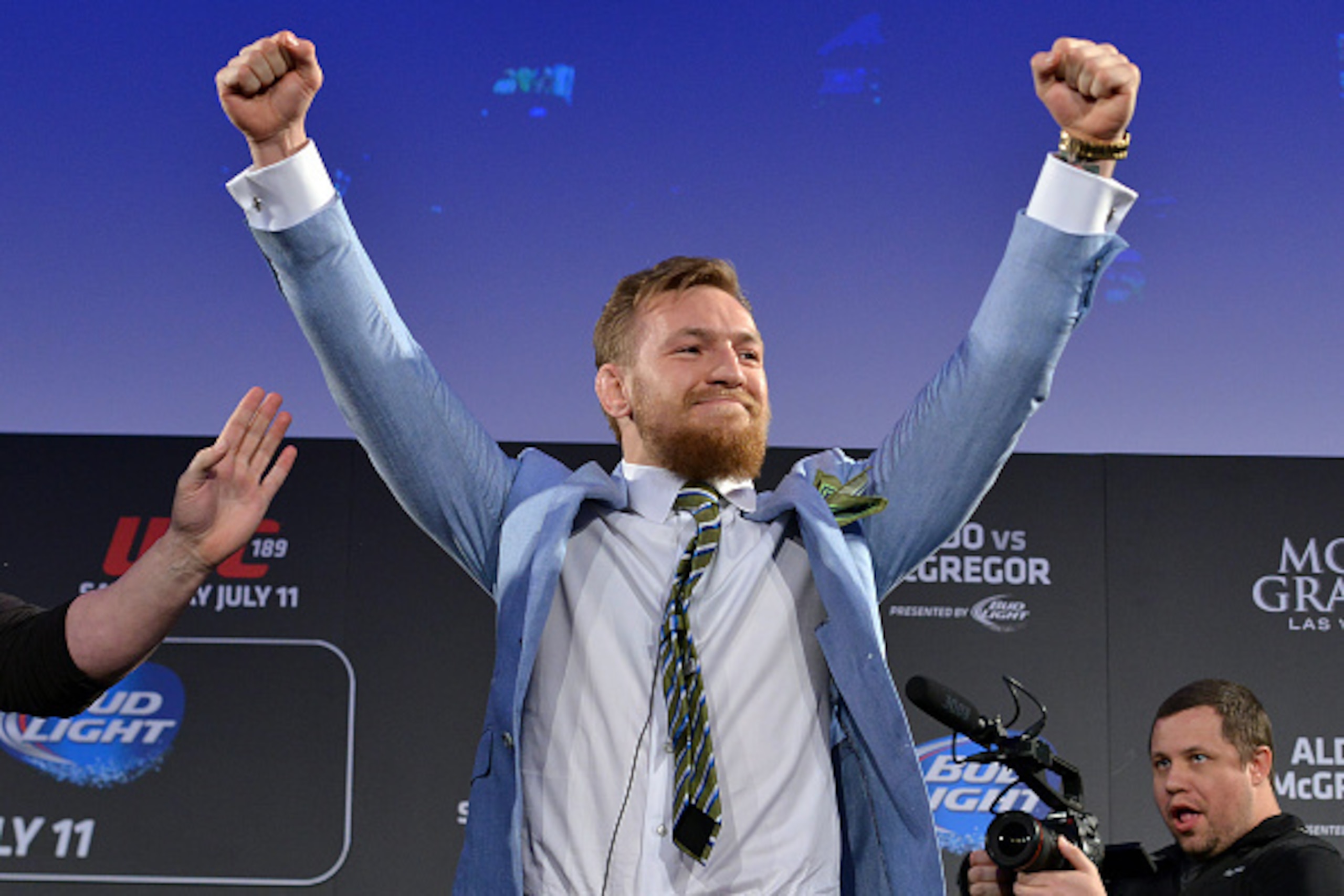 DUBLIN, IRELAND - MARCH 31:  UFC featherweight title challenger Conor 'The Notorious' McGregor reacts to fans cheers after grabbing the belt away from UFC Featherweight Champion Jose Aldo's during the UFC 189 World Championship Fan Event on March 31, 2015