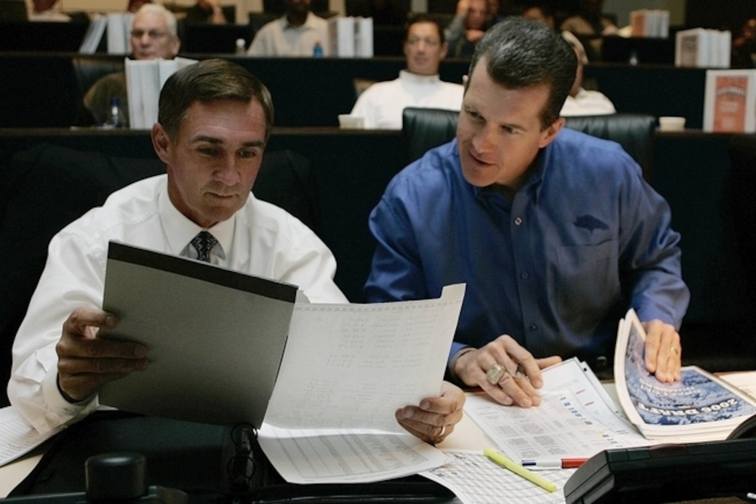 Coach Mike Shanahan and Ted Sundquist confer during the 2006 draft.