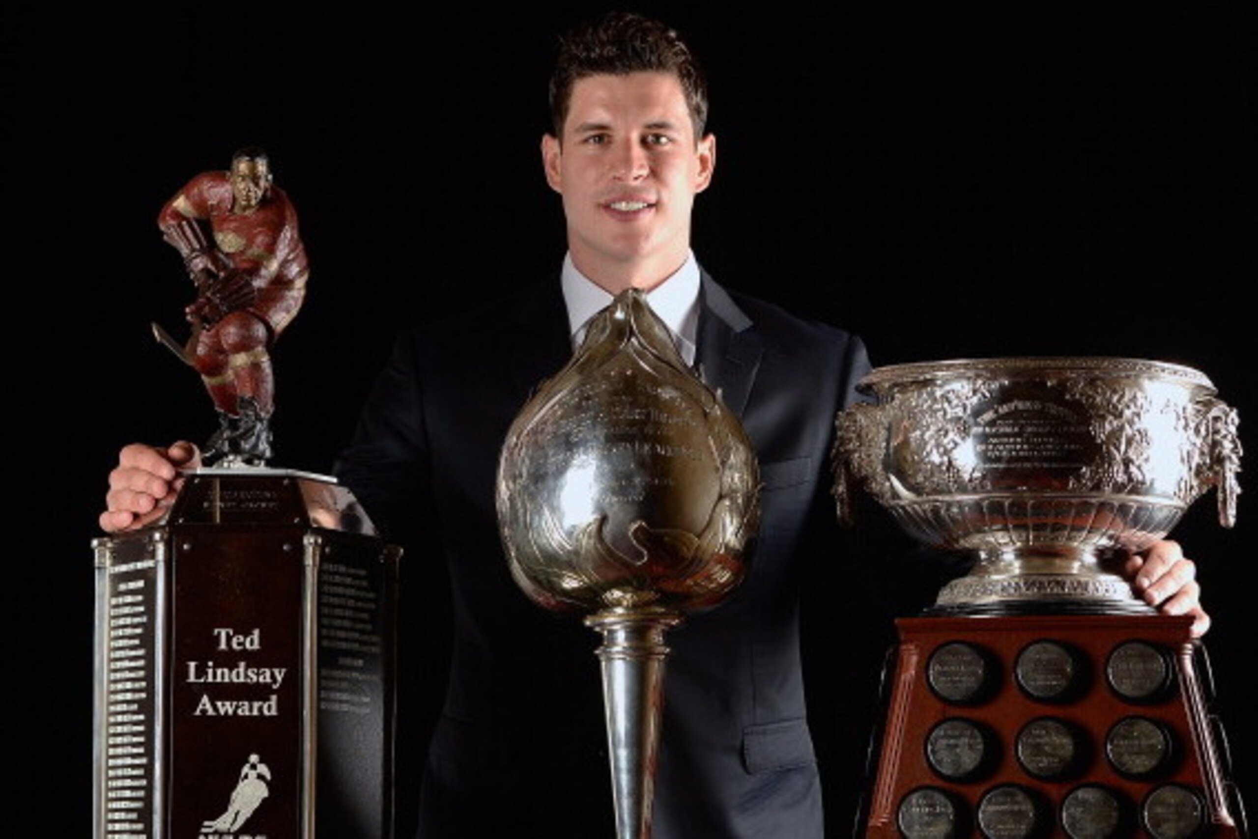 LAS VEGAS, NV - JUNE 24:  Sidney Crosby of the Pittsburgh Penguins poses with the Ted Lindsay Award, the Hart Memorial Trophy, and the Art Ross Trophy during the 2014 NHL Awards at the Encore Theater at Wynn Las Vegas on June 24, 2014 in Las Vegas, Nevada