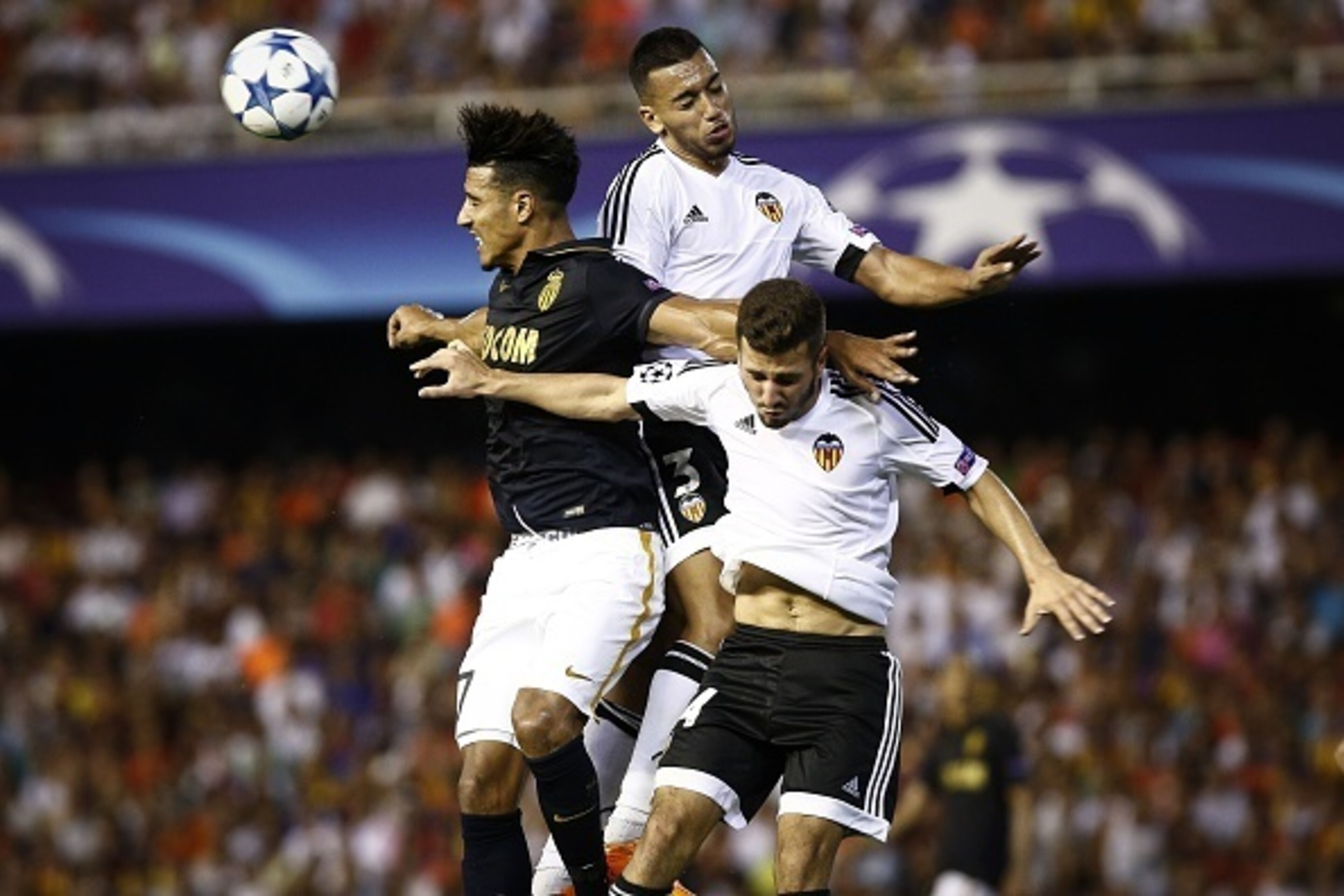 Monaco's Moroccan midfielder Nabil Dirar (R) vies with Valencia's Portuguese defender Ruben Vezo (C) and Spanish defender Jose Gaya (R) during the UEFA Champions League playoff football match between Valencia CF vs AS Monaco FC at the Mestalla stadium in 