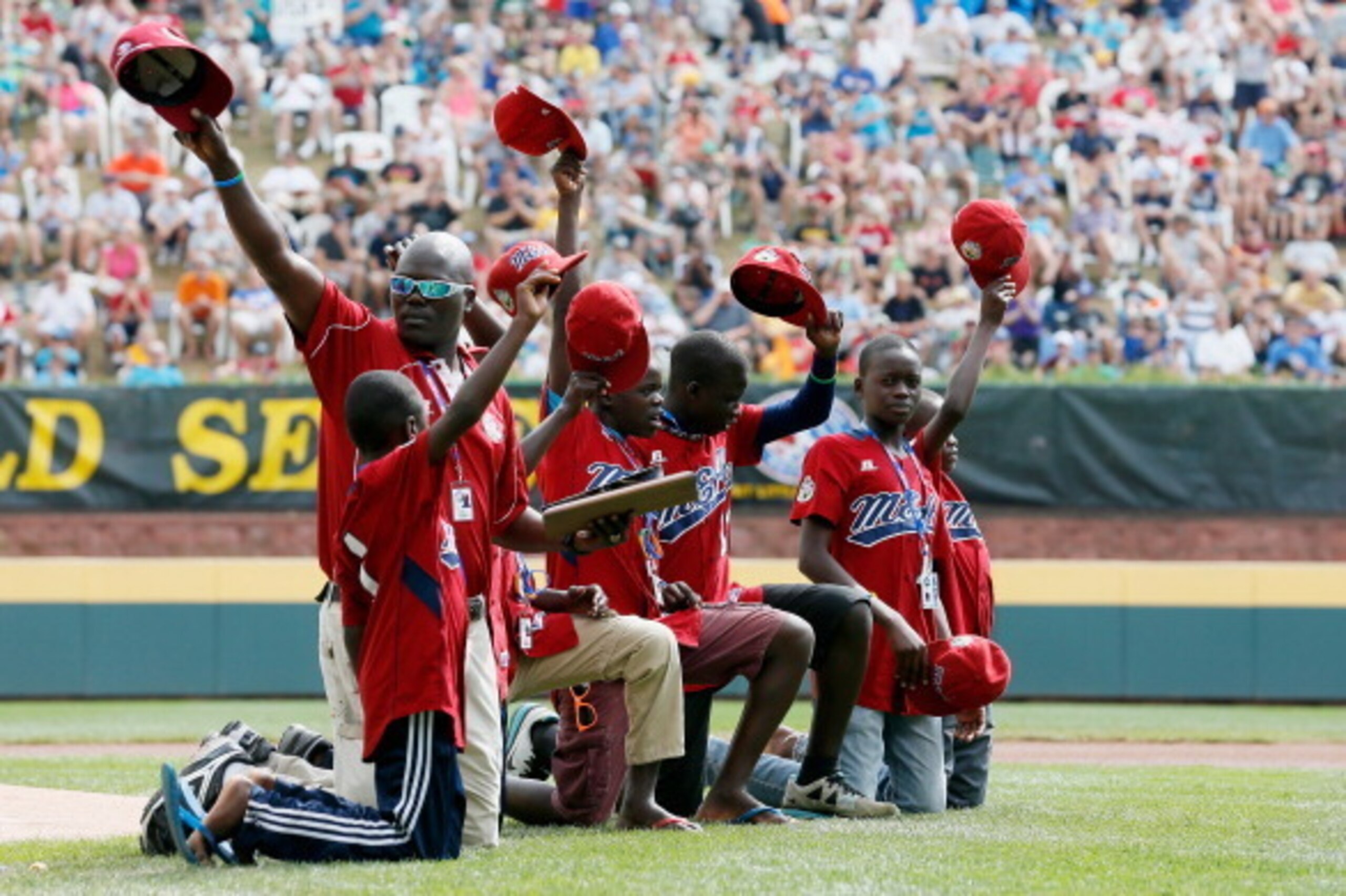 SOUTH WILLAMSPORT, PA - AUGUST 26: Members of team Uganda wave to the crowd after being acknowledged before the start of the championship game of the Little League World Series on August 26, 2012 in South Willamsport, Pennsylvania. (Photo by Rob Carr/Get SOUTH WILLAMSPORT, PA - AUGUST 26: Members of team Uganda wave to the crowd after being acknowledged before the start of the championship game of the Little League World Series on August 26, 2012 in South Willamsport, Pennsylvania. (Photo by Rob Carr/Get
