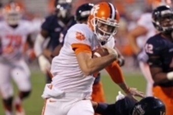 Nov 2, 2013; Charlottesville, VA, USA; Clemson Tigers quarterback Chad Kelly (11) runs with the ball past Virginia Cavaliers defensive tackle Donte Wilkins (93) to score a touchdown in the fourth quarter at Scott Stadium. The Tigers won 59-10. Mandatory C