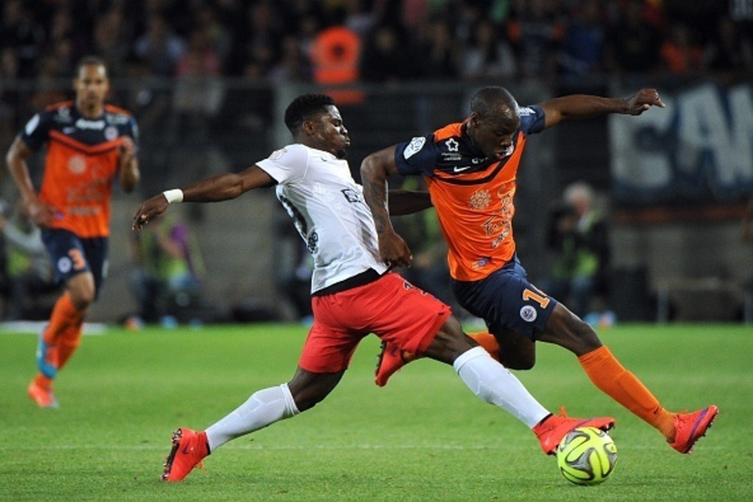 Montpellier's Senegalese forward Souleymane Camara (R) vies for the ball with Paris Saint-Germain's Ivorian defender Serge Aurier  during the French L1 football match between Montpellier (MHSC) and Paris Saint-Germain (PSG) on May 16, 2015 at La Mosson St
