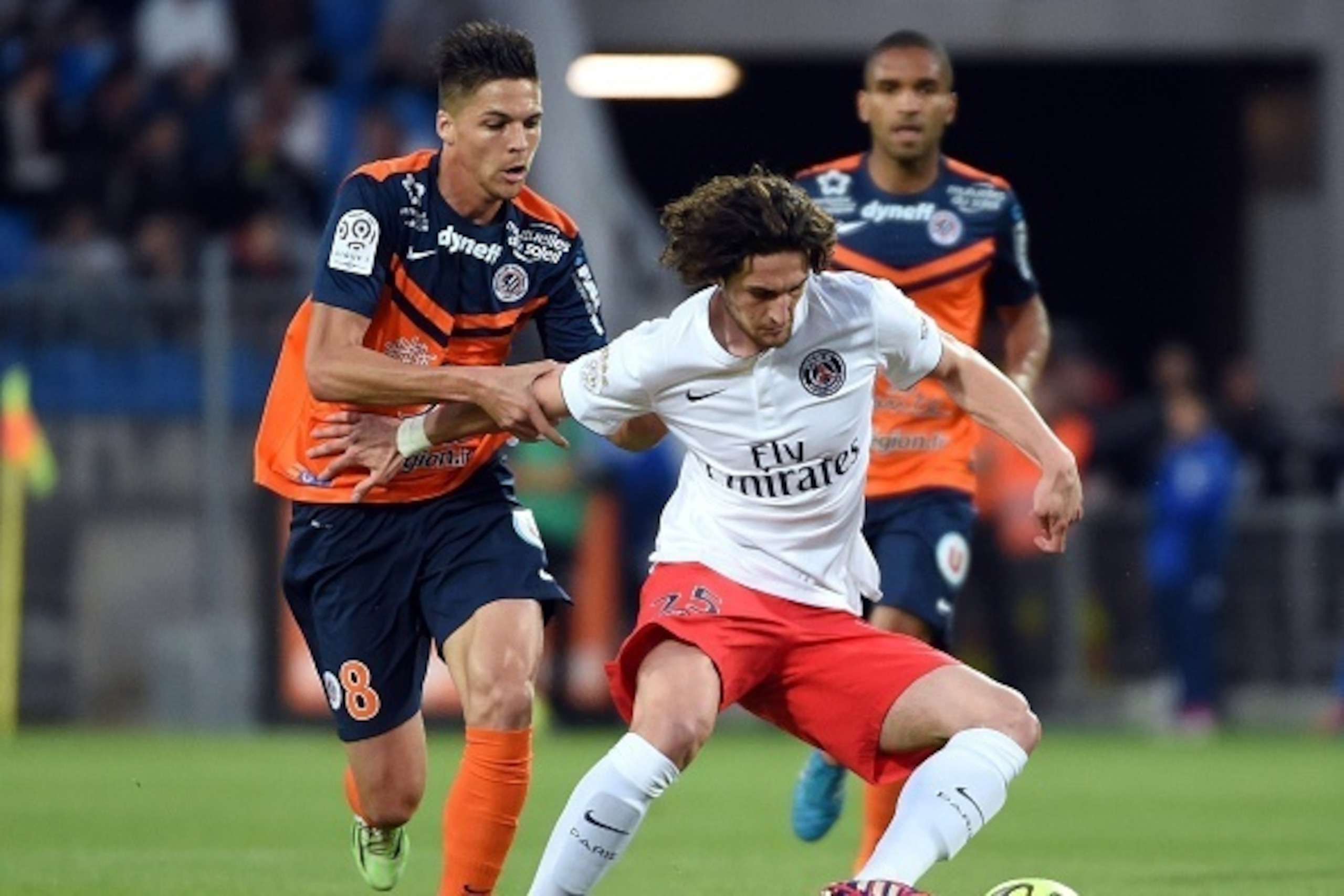 Montpellier's French midfielder Jonas Martin (L) vies for the ball with Paris Saint-Germain's French  midfielder Adrien Rabiot (R)   during the French L1 football match between Montpellier (MHSC) and Paris Saint-Germain (PSG) on May 16, 2015 at La Mosson