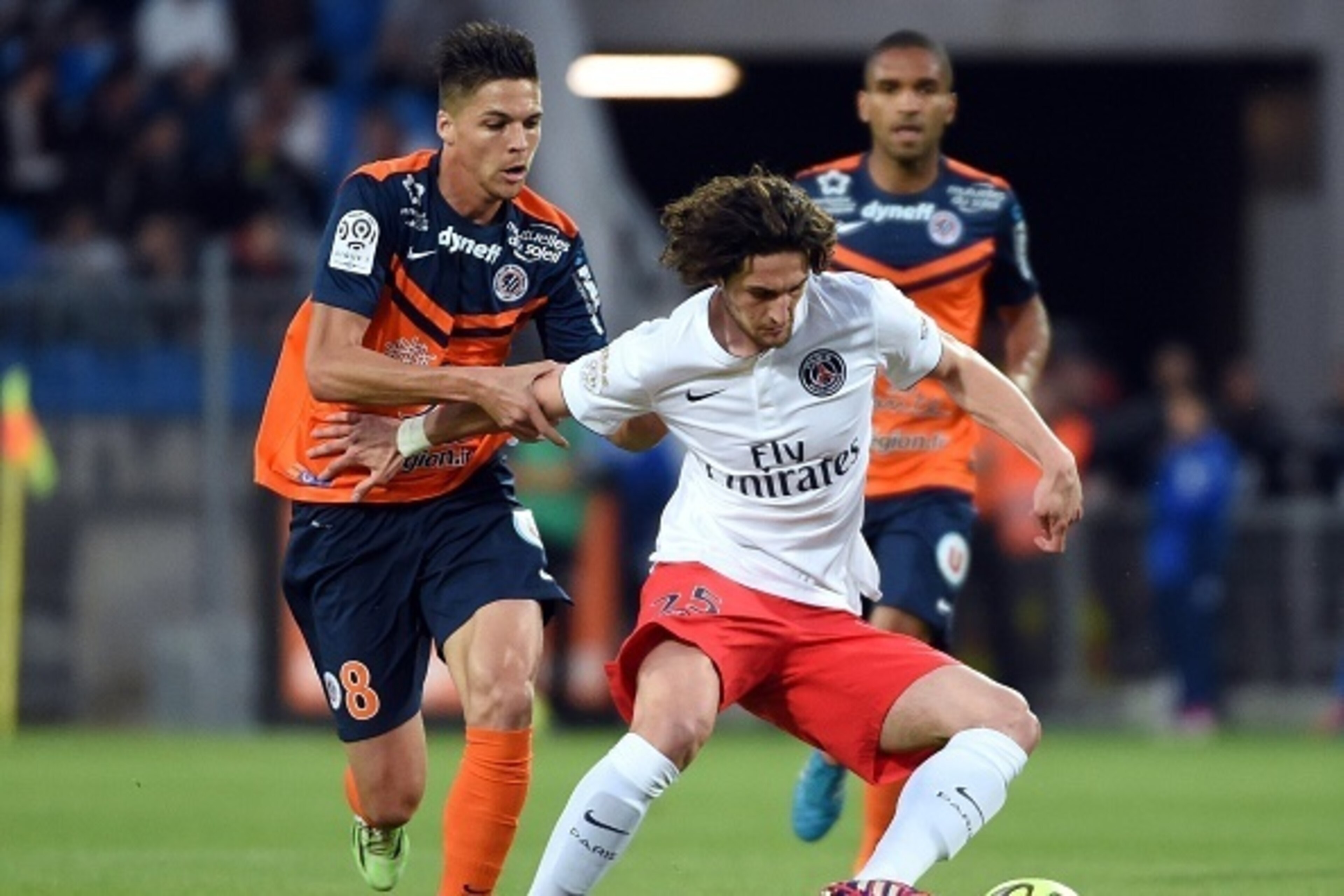 Montpellier's French midfielder Jonas Martin (L) vies for the ball with Paris Saint-Germain's French  midfielder Adrien Rabiot (R)   during the French L1 football match between Montpellier (MHSC) and Paris Saint-Germain (PSG) on May 16, 2015 at La Mosson