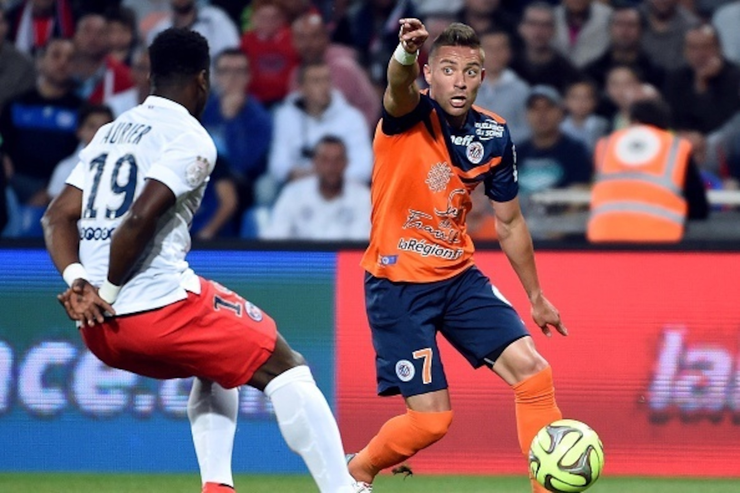 Montpellier's French forward Anthony Mounier (R) gestures as he vies for the ball with Paris Saint-Germain's Ivorian defender Serge Aurier (L)  during the French L1 football match between Montpellier (MHSC) and Paris Saint-Germain (PSG) on May 16, 2015 at