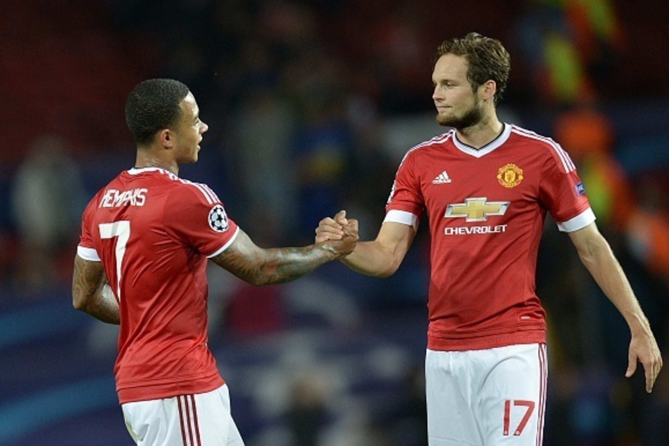 Manchester United's Dutch midfielder Memphis Depay (L) and Manchester United's Dutch midfielder Daley Blind are pictured after winning 3-1 during the UEFA Champions League play off football match between Manchester United and Club Brugge at Old Trafford i