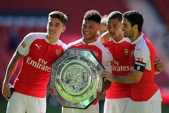 LONDON, ENGLAND -  AUGUST 2:  Arsenal goalscorer Alex Oxlade-Chamberlain celebrates with the FA Community Shield trophy with team-mates Hector Bellerin, Kieran Gibbs and Mikel Arteta after the FA Community Shield match between Chelsea and Arsenal at Wembl
