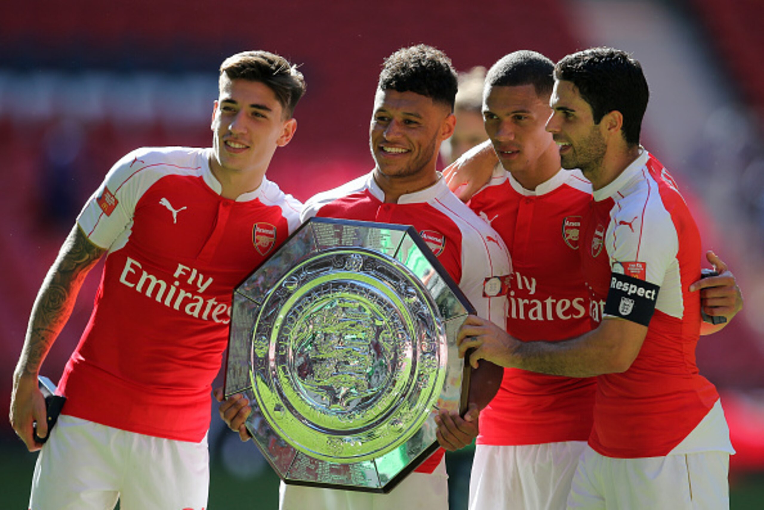 LONDON, ENGLAND - AUGUST 2: Arsenal goalscorer Alex Oxlade-Chamberlain celebrates with the FA Community Shield trophy with team-mates Hector Bellerin, Kieran Gibbs and Mikel Arteta after the FA Community Shield match between Chelsea and Arsenal at Wembl LONDON, ENGLAND - AUGUST 2: Arsenal goalscorer Alex Oxlade-Chamberlain celebrates with the FA Community Shield trophy with team-mates Hector Bellerin, Kieran Gibbs and Mikel Arteta after the FA Community Shield match between Chelsea and Arsenal at Wembl