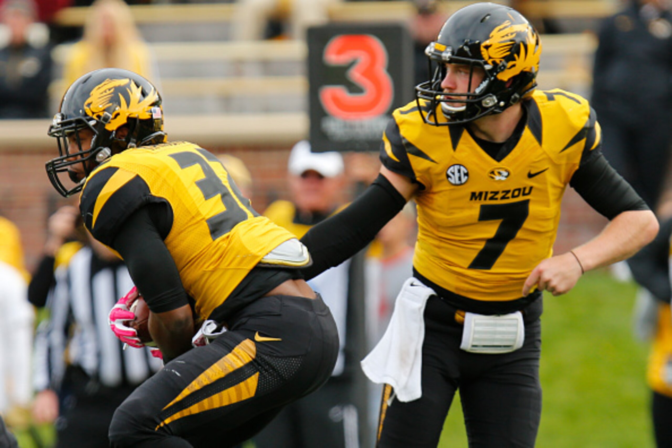 COLUMBIA, MO - OCTOBER 11: Maty Mauk #7 hands off to Russell Hansbrough #32 of the Missouri Tigers and drives up the field against the Georgia Bulldogs defense in the second half on October 11, 2014 at Faurot Field/Memorial Stadium in Columbia, Missouri. 