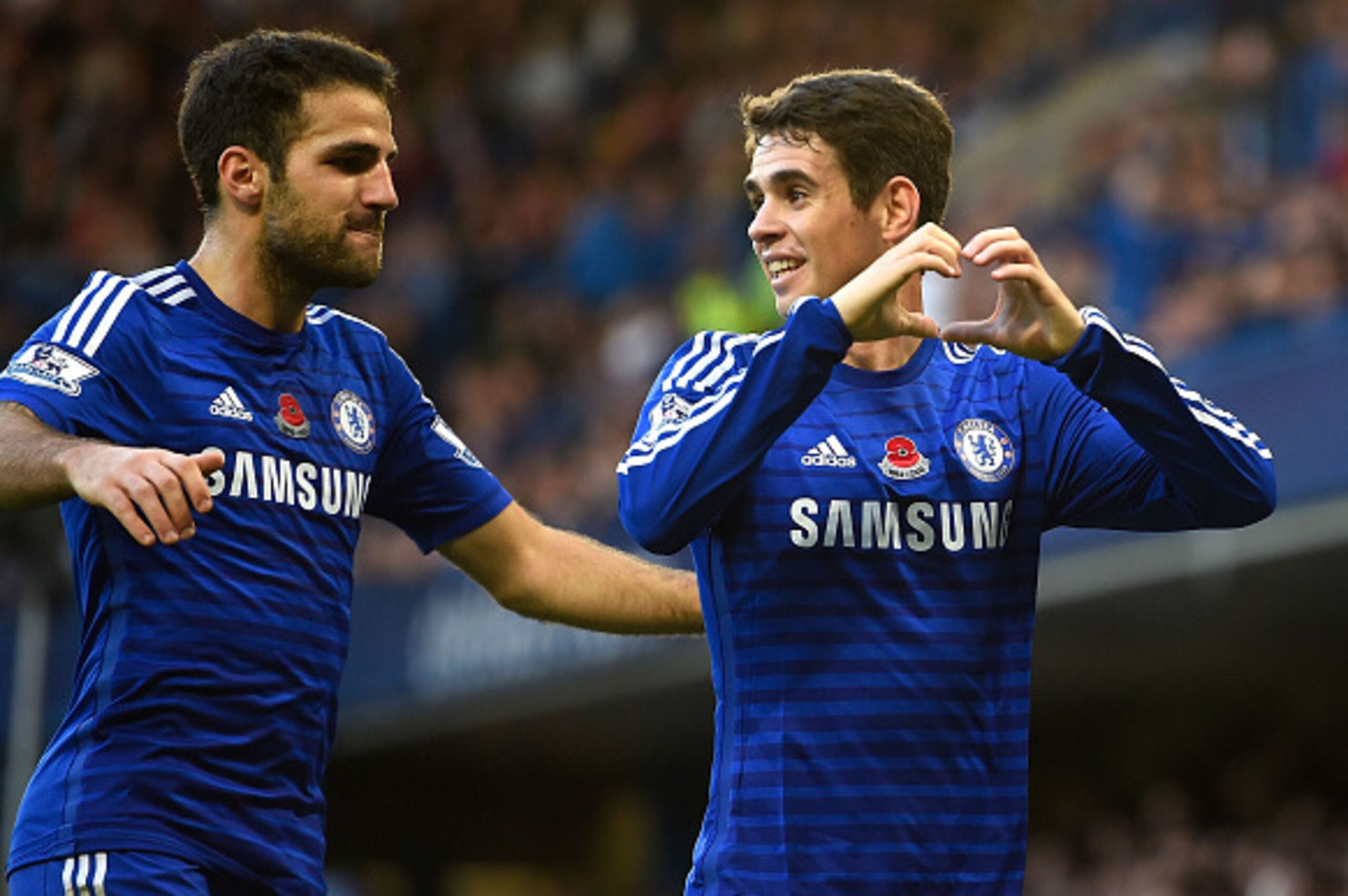 LONDON, ENGLAND - NOVEMBER 01:  Oscar of Chelsea celebrates his goal with Cesc Fabregas during the Barclays Premier League match between Chelsea and Queens Park Rangers at Stamford Bridge on November 1, 2014 in London, England.  (Photo by Mike Hewitt/Gett