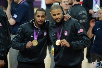 LONDON, ENGLAND - AUGUST 12:Carmelo Anthony #15 and Tyson Chander #4 of the US Men's Senior National Team poses for a photo with the Gold Medal after their Men's Gold Medal Basketball Game against Spain on Day 16 of the London 2012 Olympic Games at the No