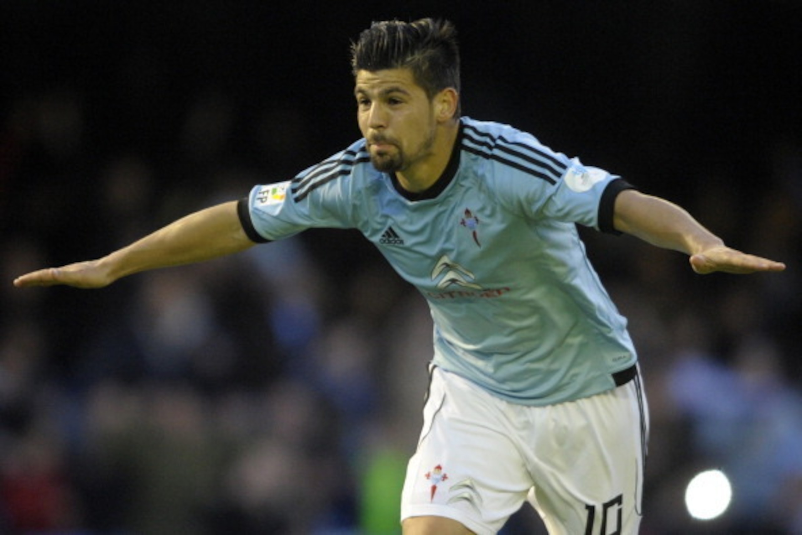 Celta's forward Nolito celebrates after scoring a goal during the Spanish league football match RC Celta de Vigo vs Sevilla FC at the Balaidos stadium in Vigo on March 29, 2014. Celta won the match 1-0.  AFP PHOTO / MIGUEL RIOPA        (Photo credit shoul