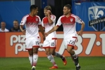 Aug 8, 2015; Montreal, Quebec, CAN; D.C. United forward Chris Rolfe (18) celebrates his goal against Montreal Impact with teammates forward Jairo Arrieta (19) and defender Chris Korb (22) during the first half at Stade Saputo. Mandatory Credit: Jean-Yves 
