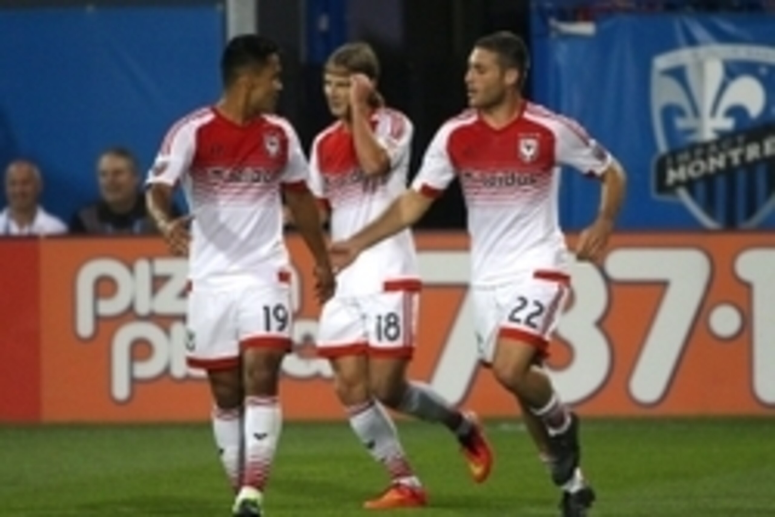 Aug 8, 2015; Montreal, Quebec, CAN; D.C. United forward Chris Rolfe (18) celebrates his goal against Montreal Impact with teammates forward Jairo Arrieta (19) and defender Chris Korb (22) during the first half at Stade Saputo. Mandatory Credit: Jean-Yves 