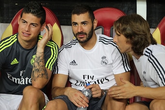 GUANGZHOU, CHINA - JULY 27: James Rodriguez, Benzema and Luka Modric of Real Madrid talk on the bench during the match of International Champions Cup China 2015 between Real Madrid and FC Internazionale at Tianhe Stadium on July 27, 2015 in Guangzhou, Chi