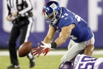 Oct 21, 2013; East Rutherford, NJ, USA; New York Giants running back Peyton Hillis (44) fumbles on a hit by Minnesota Vikings middle linebacker Erin Henderson (50) in the second quarter at MetLife Stadium.  Hillis recovered his own fumble on this play. Ma
