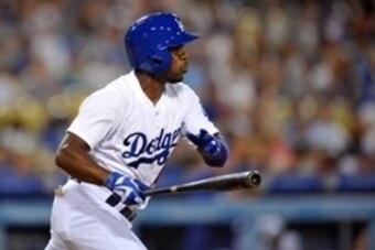 August 15, 2015; Los Angeles, CA, USA; Los Angeles Dodgers shortstop Jimmy Rollins (11) hits a single in the sixth inning against the Cincinnati Reds  at Dodger Stadium. Mandatory Credit: Gary A. Vasquez-USA TODAY Sports