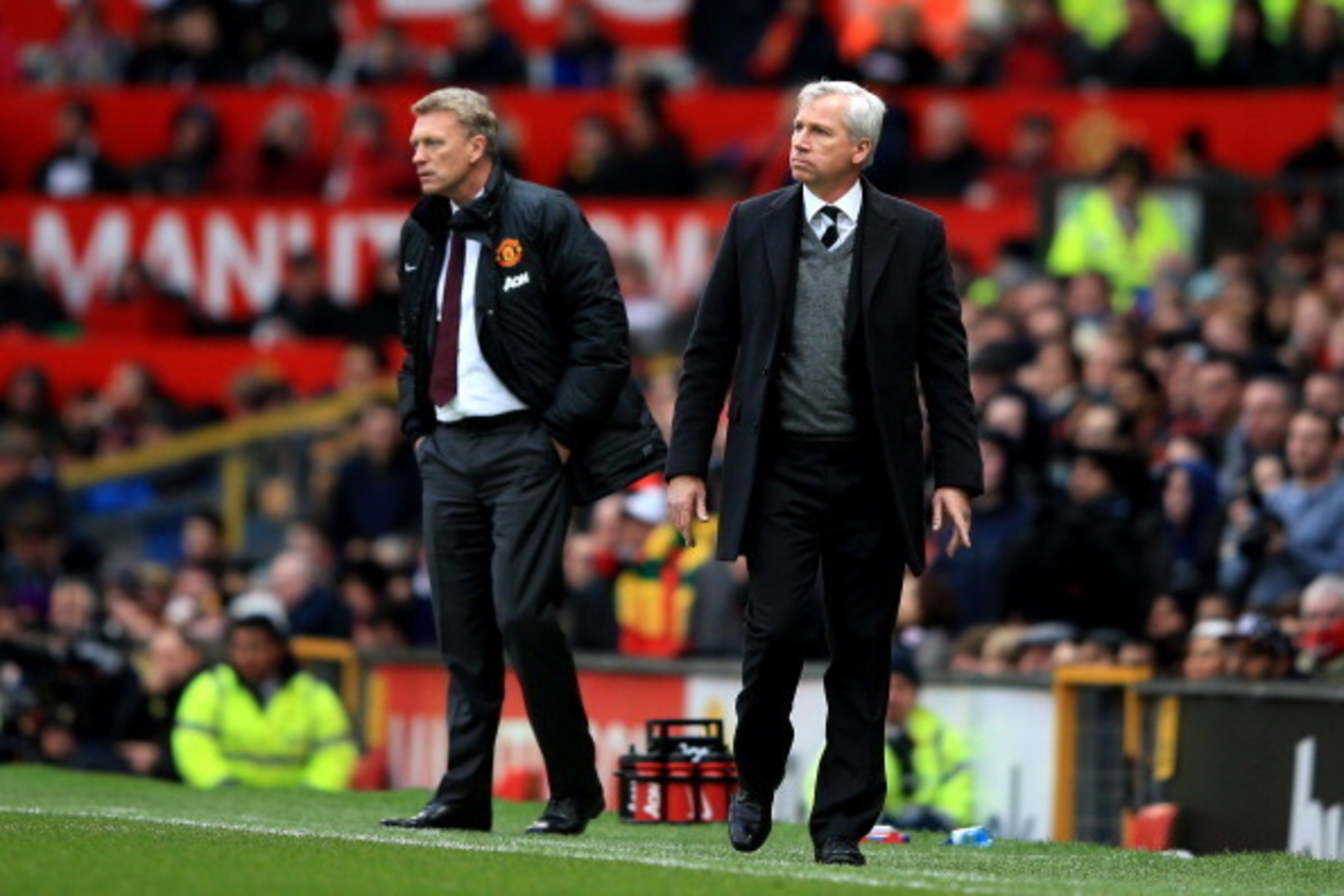 MANCHESTER, ENGLAND - DECEMBER 07:  David Moyes the Manchester United manager and Alan Pardew the Newcastle manager look on during the Barclays Premier League match between Manchester United and Newcastle United at Old Trafford on December 7, 2013 in Manc