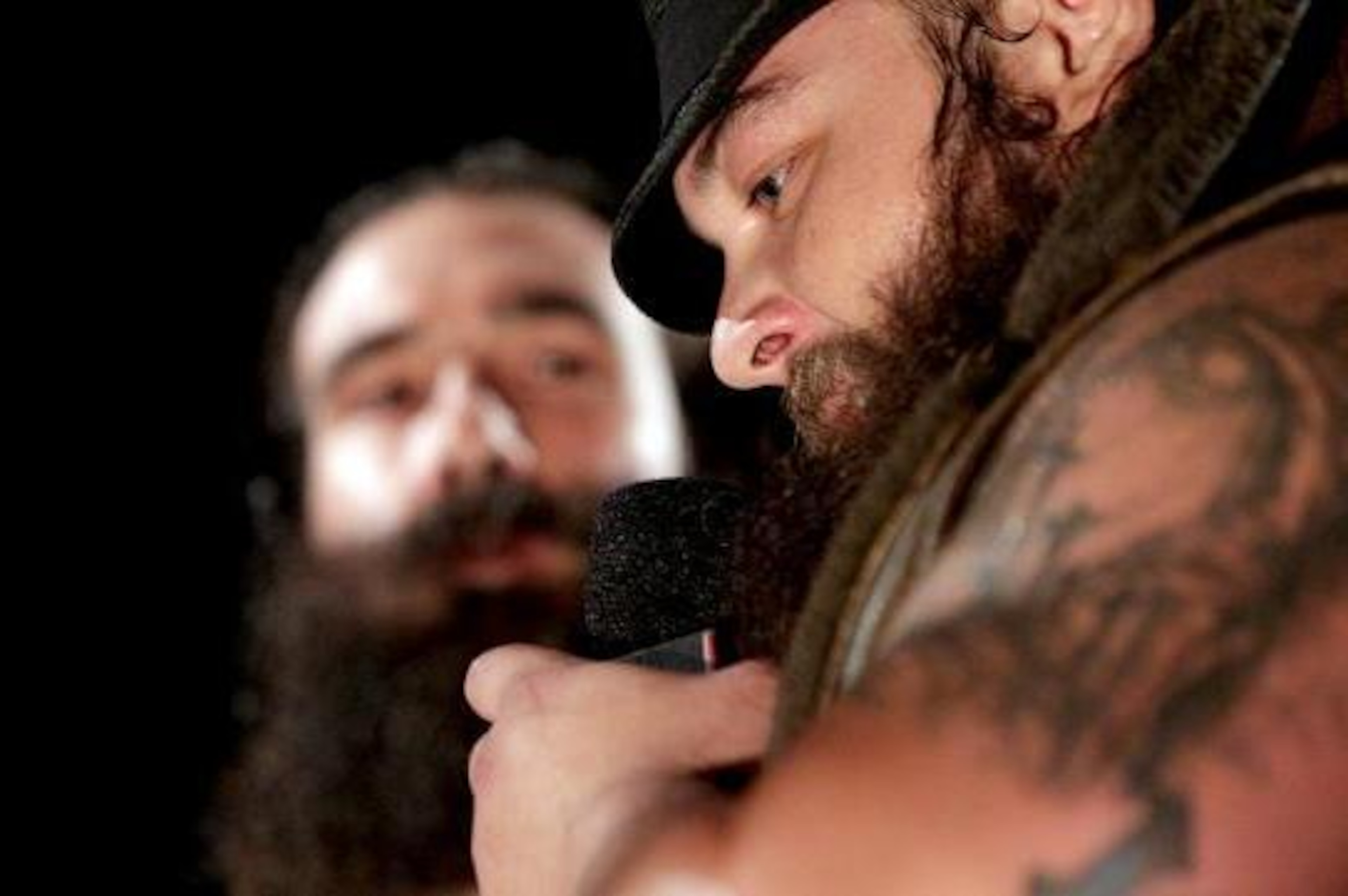 Luke Harper watches on as Bray Wyatt addresses the crowd.