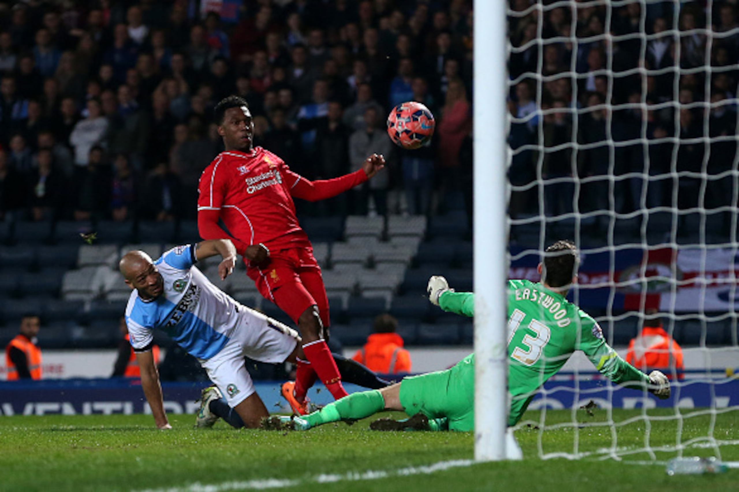 BLACKBURN, ENGLAND - APRIL 08:  Daniel Sturridge of Liverpool misses a shot at goal under pressure from  Alex Baptiste and Goalkeeper Simon Eastwood of Blackburn Rovers during the FA Cup Quarter Final Replay match between Blackburn Rovers and Liverpool at