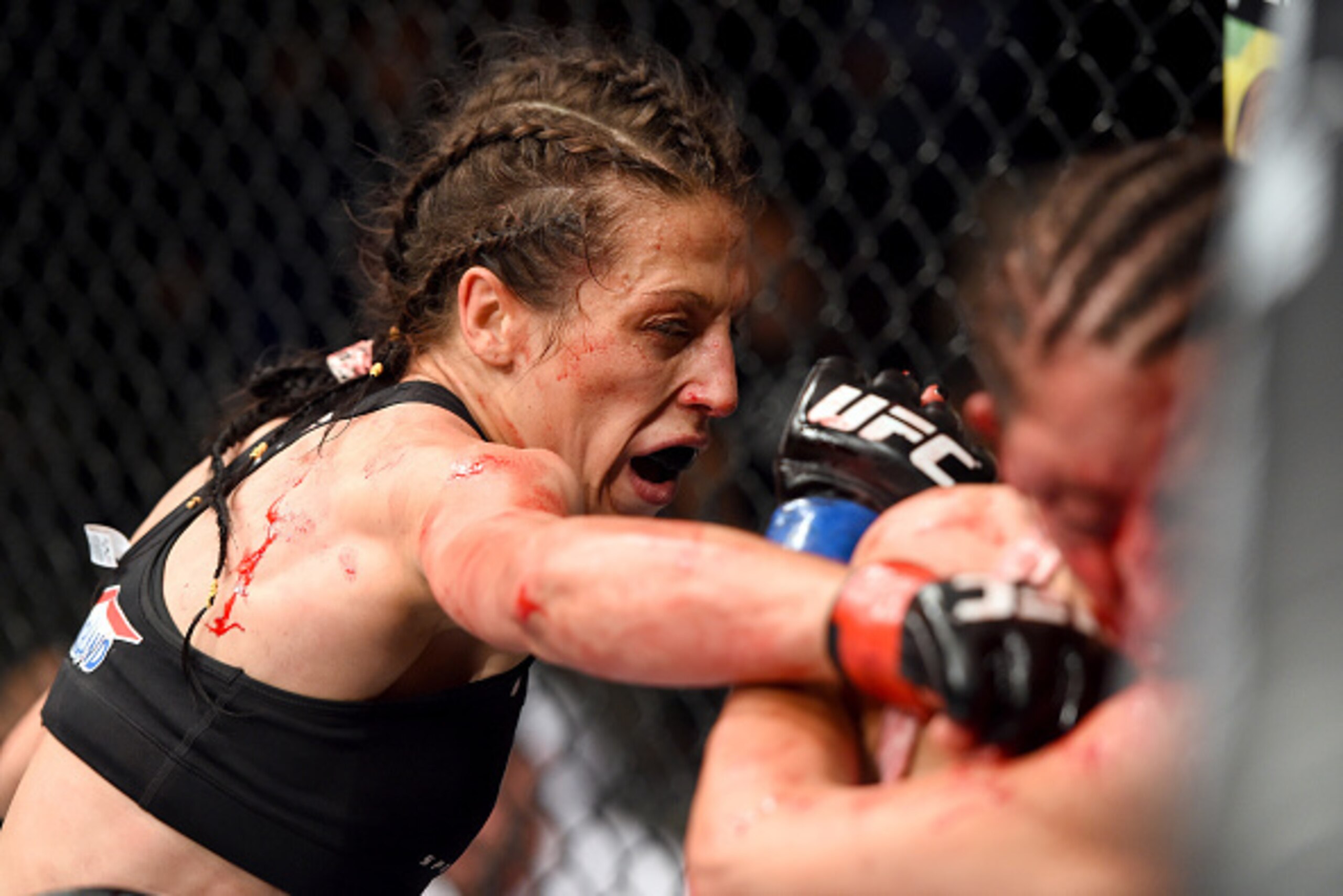BERLIN, GERMANY - JUNE 20:   (L-R) Joanna Jedrzejczyk of Poland punches Jessica Penne of the United States in their women's strawweight championship bout during the UFC Fight Night event at the O2 World on June 20, 2015 in Berlin, Germany. (Photo by Josh 