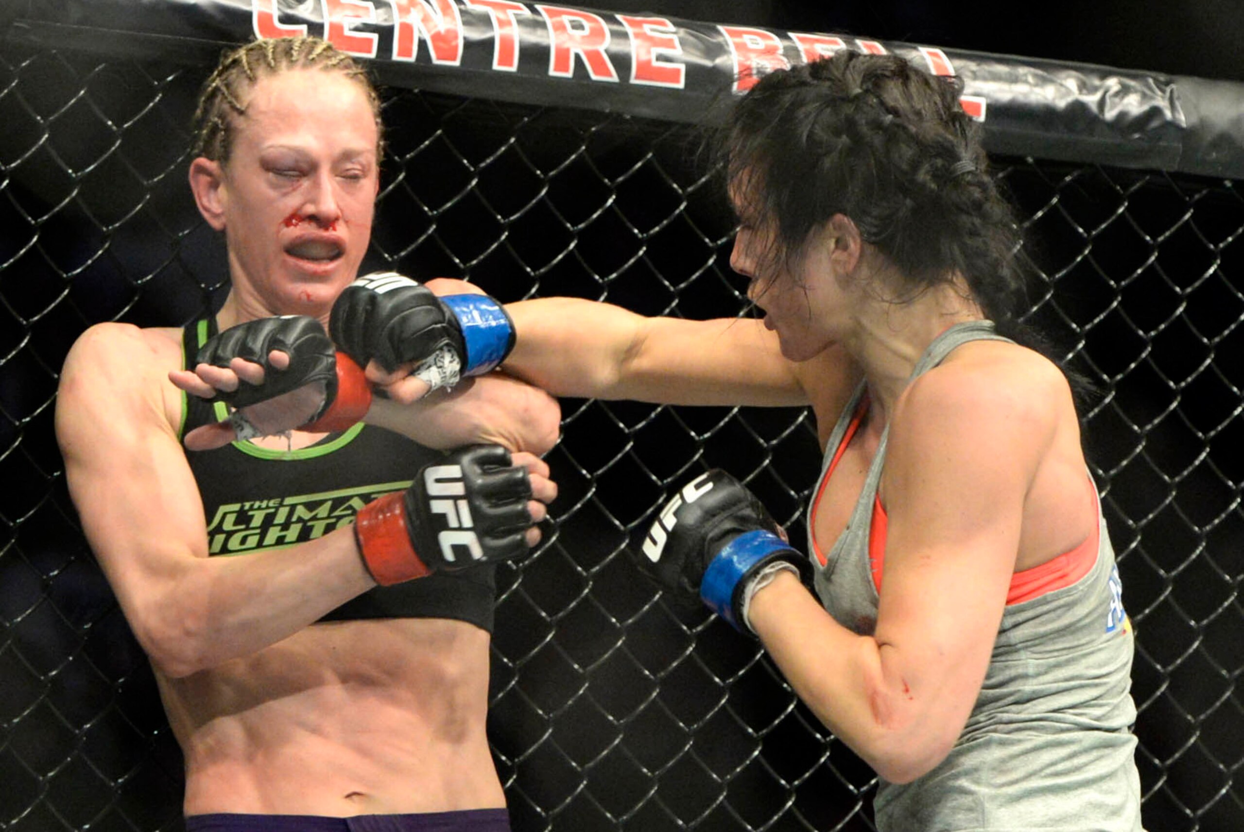 Apr 25, 2015; Montreal, Quebec, CAN; Jessica Rakoczy (red) and Valerie Letourneau (blue) fight during their women's strawweight bout during UFC 186 at Bell Centre. Mandatory Credit: Eric Bolte-USA TODAY Sports