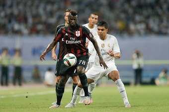 SHANGHAI, CHINA - JULY 30: Niang M'baye Hamady of AC Milan contests the ball against Casemiro (R) of Real Madrid during the International Champions Cup match between Real Madrid and AC Milan at Shanghai Stadium on July 30, 2015 in Shanghai, China.  (Photo