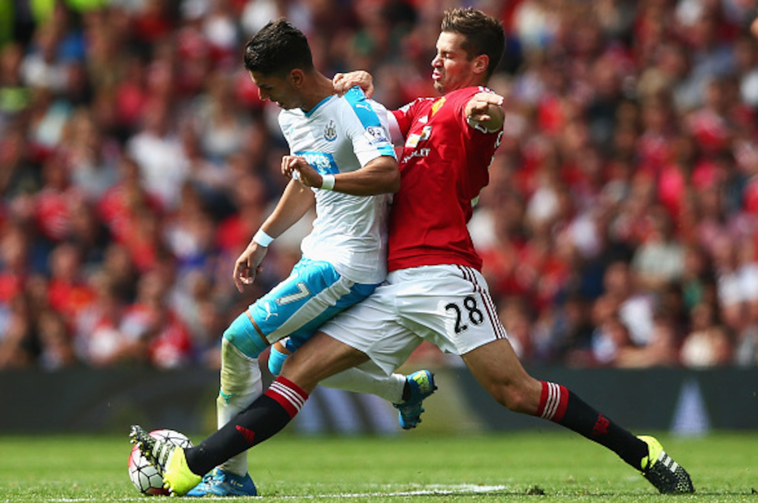 MANCHESTER, ENGLAND - AUGUST 22:  Ayoze Perez of Newcastle United and Morgan Schneiderlin of Manchester United compete for the ball  during the Barclays Premier League match between Manchester United and Newcastle United at Old Trafford on August 22, 2015