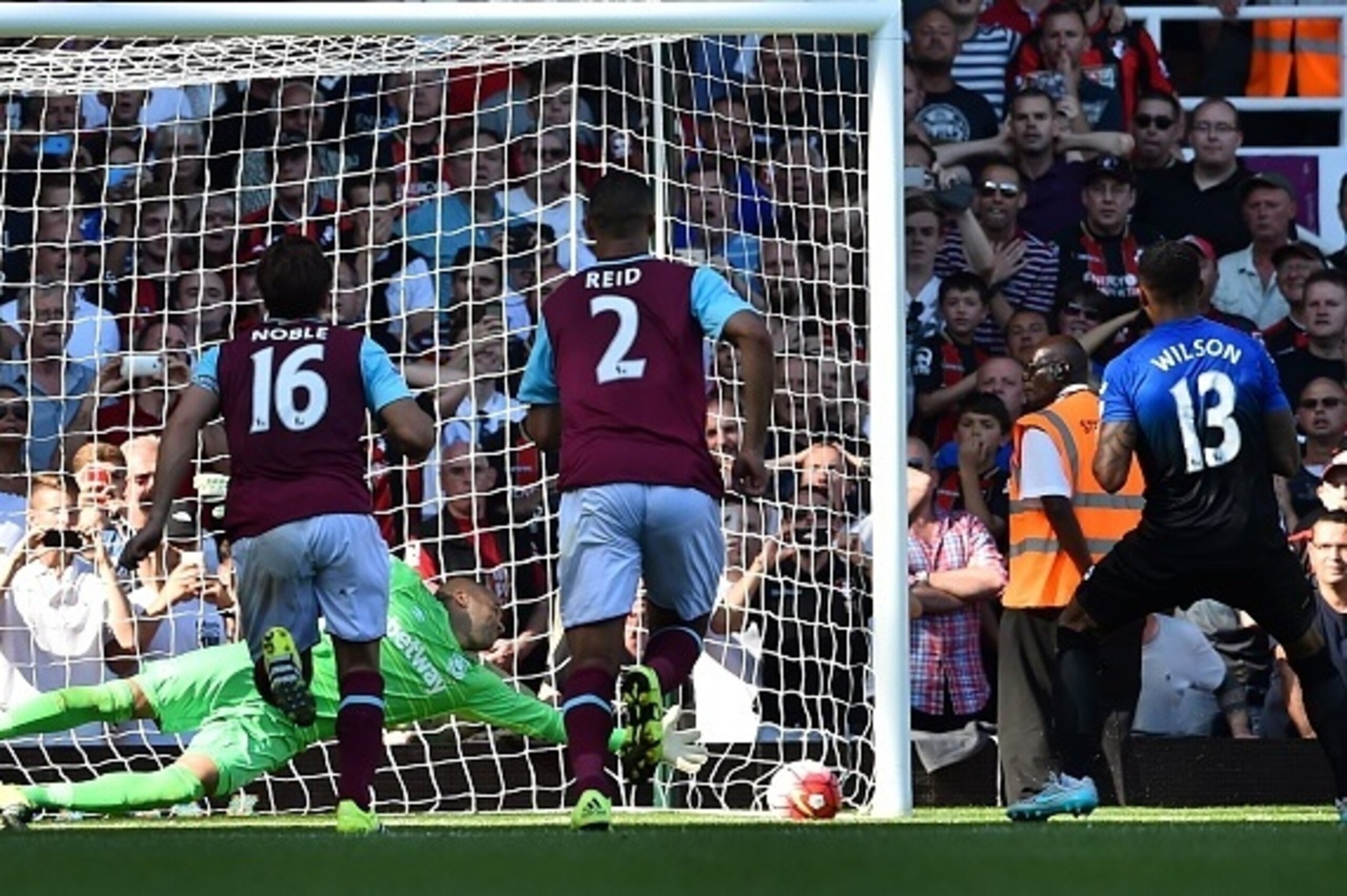 Bournemouth's English striker Callum Wilson (R) scores his third goal from the penalty spot past West Ham United's Irish goalkeeper Darren Randolph during the English Premier League football match between West Ham United and Bournemouth at The Boleyn Grou