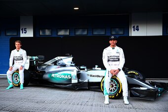 JEREZ DE LA FRONTERA, SPAIN - FEBRUARY 01:  Lewis Hamilton of Great Britain and Mercedes GP and Nico Rosberg of Germany and Mercedes GP pose with the new W06 at its launch outside the team garage during day one of Formula One Winter Testing at Circuito de