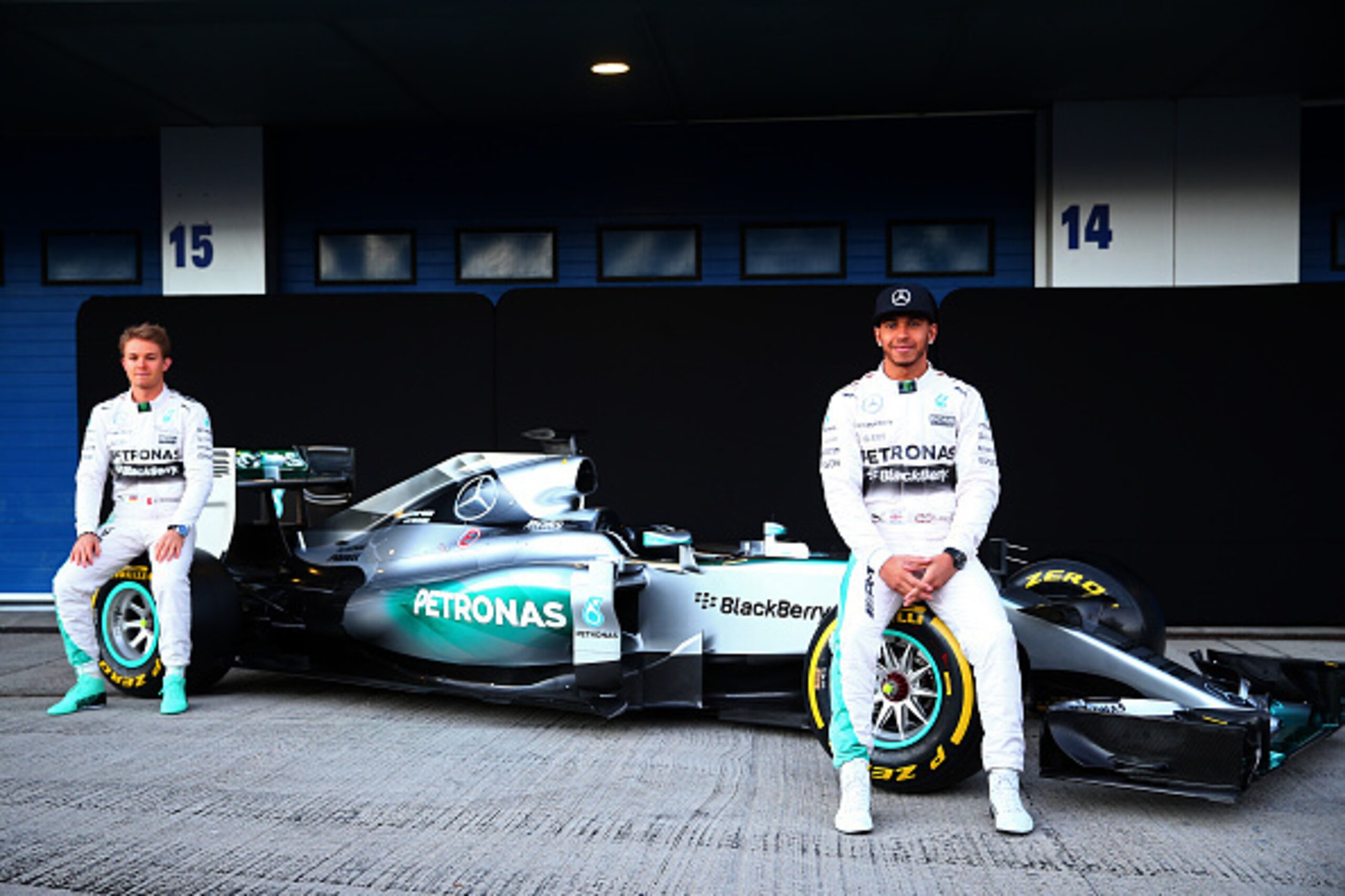 JEREZ DE LA FRONTERA, SPAIN - FEBRUARY 01:  Lewis Hamilton of Great Britain and Mercedes GP and Nico Rosberg of Germany and Mercedes GP pose with the new W06 at its launch outside the team garage during day one of Formula One Winter Testing at Circuito de