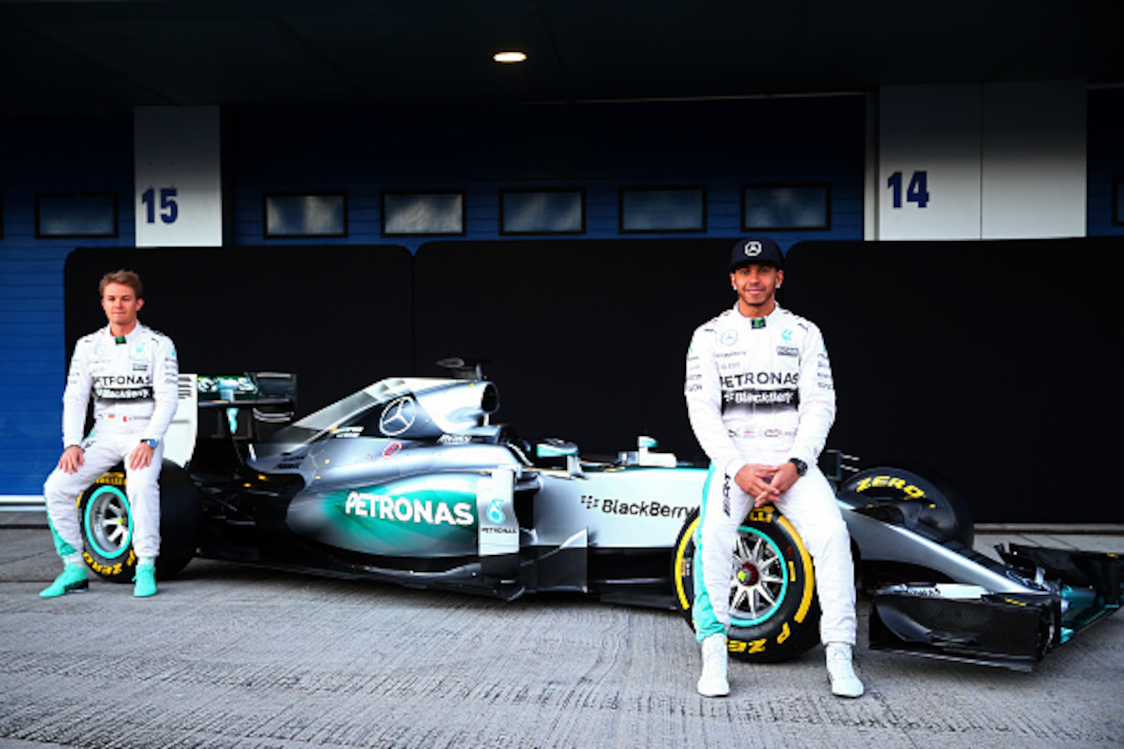 JEREZ DE LA FRONTERA, SPAIN - FEBRUARY 01:  Lewis Hamilton of Great Britain and Mercedes GP and Nico Rosberg of Germany and Mercedes GP pose with the new W06 at its launch outside the team garage during day one of Formula One Winter Testing at Circuito de
