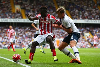 LONDON, ENGLAND - AUGUST 15:  Mame Biram Diouf of Stoke City and Jan Vertonghen of Tottenham Hotspur compete for the ball during the Barclays Premier League match between Tottenham Hotspur and Stoke City at White Hart Lane on August 15, 2015 in London, Un